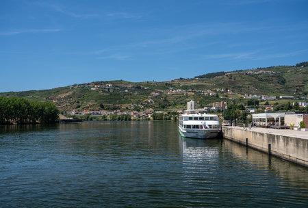 Regua, Portugal - 13 August 2019: River cruise boat Fernao de Magalhaes docked by the side of Douro riverのeditorial素材