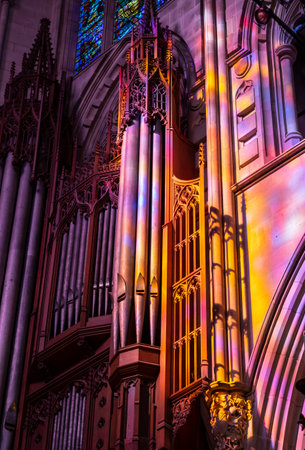 Washington, DC - 4 November 2019: Sunbeams from the stained glass windows light up the organ pipes in National Cathedral in Washington DCのeditorial素材