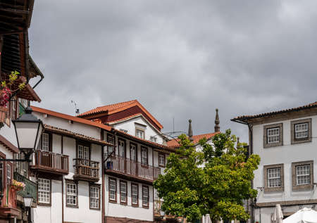 Carved balconies on traditional houses overlooking the main square in Guimaraesの写真素材