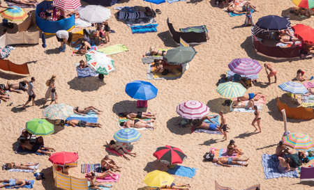 Nazare, Portugal - 20 August 2019: Crowded beach of Nazare from above with tourists relaxing on the sandのeditorial素材