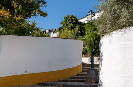 Steep pathway to homes in the old medieval walled city of Obidos in Portugal