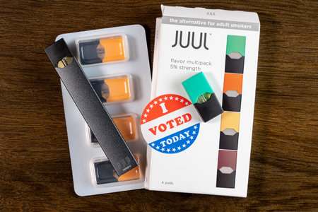 Morgantown, WV - 2 January 2020: Juul flavored nicotine vaping system with I Voted sticker to...