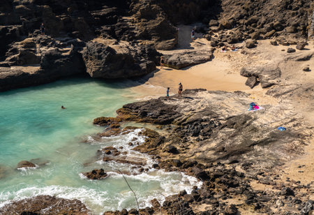 Waikiki, HI - 23 January 2020: Tourists swim in Halona Beach Cove near the blowhole in Oahu, Hawaiiのeditorial素材