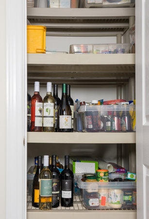 Morgantown, WV - 19 March 2020: Selection of groceries for home storage during quarantine due to Coronavirus epidemic with focus on wine bottlesのeditorial素材