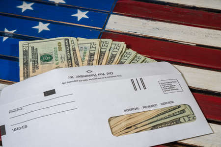Stack of 20 dollar bills in IRS envelope to illustrate coronavirus stimulus payment or estimated tax paymentsの写真素材