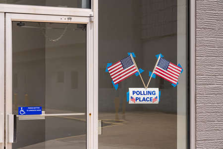 USA flags stuck to window of Polling place for early voting in the USA elections