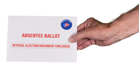 Absentee ballot voting by mail envelope being handed in by a senior mans hand as alternative to...
