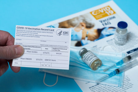 Morgantown, WV - 22 February 2021: Covid-19 vaccination record card showing first and second doses of Pfizer vaccine in West Virginiaのeditorial素材