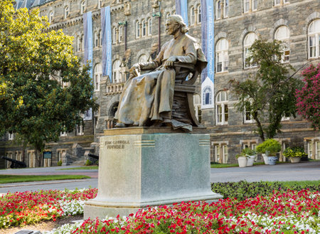 Washington DC - 13 August 2013: Statue of John Carroll in front of Healy Hall the historic flagship building of Georgetown Universityのeditorial素材