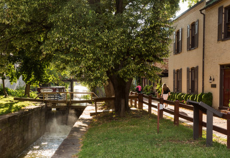 Washington DC - 13 August 2013: Old wooden lock gates on the canal in Georgetown by Washington DC with old homes lining the streetのeditorial素材