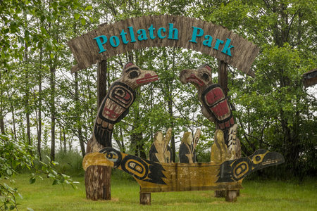 Ketchikan, AK - 10 June 2022: Totem poles and welcome sign in Potlatch Park in Ketchikan Alaskaのeditorial素材