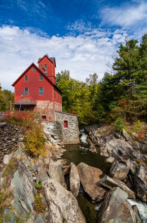 Side view of the Old Red Mill by the creek in Jericho Vermont during the fallの写真素材