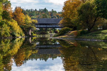 Ottauquechee river flows under Middle Covered Bridge in Woodstock VT