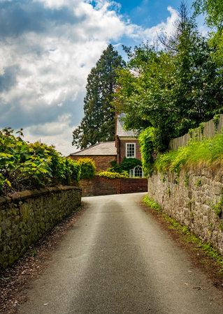 Old brick georgian home behind garden wall seen from Church Hill in Ellesmere Shropshireの写真素材