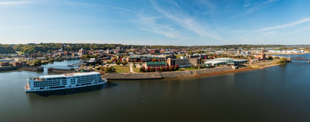 Dubuque, IA - 17 October 2023: Aerial view of Viking Mississippi river cruise boat docked by modern convention center on Mississippi river in Iowaのeditorial素材