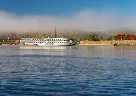 Upper Mississippi on calm misty morning at Dubuque with docked river cruise boatの写真素材