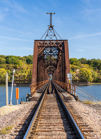 Historic Dubuque railroad bridge between Iowa and Illinois across the Mississippi river with swing span open for shippingの写真素材