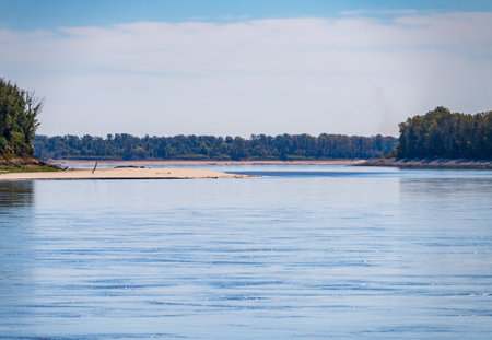 Low water levels in the lower Mississippi river expose sand bars and create narrow shipping channels for bargesの写真素材