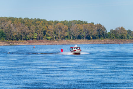 Small speeding boat coming down the Mississippi river near Cairo in Illinoisの写真素材