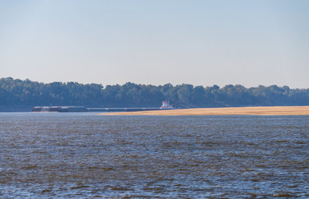 Panorama of sand banks due to extreme low water conditions on Mississippi river in October 2023 with a large barge rounding a bend near Greenville, MSの写真素材