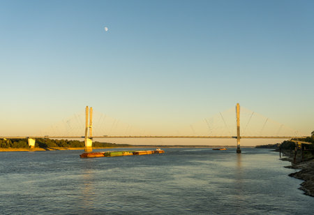 Modern cable-stayed suspension bridge, the Jesse Brent Memorial bridge across the Mississippi river near Greenville with river bargeの写真素材