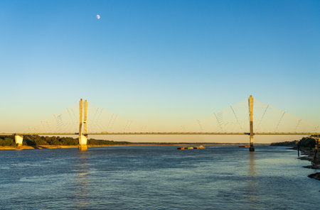 Modern cable-stayed suspension bridge, the Jesse Brent Memorial bridge across the Mississippi river near Greenville with river bargeの写真素材