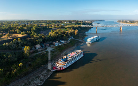 Natchez, MS - 26 October 2023: Viking Mississippi cruise boat and traditional American Queen riverboat docked under the hillのeditorial素材