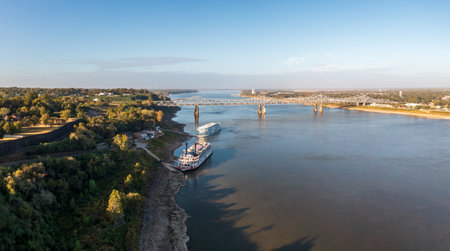 Modern Mississippi cruise boat and traditional riverboat docked by the bluff under the hill in Natchez Mississippiの写真素材