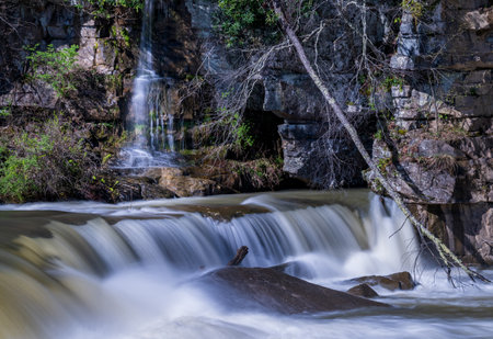 Small waterfall cascade on rocks by Valley Falls State Park near Fairmont in West Virginia on a colorful and bright spring dayの写真素材