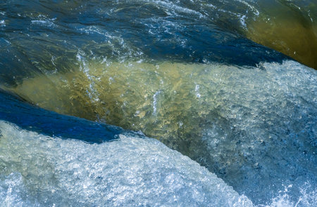 Frozen motion view of raging water flowing over rocks of Valley Falls State Park on Tygart River near Fairmont West Virginiaの写真素材