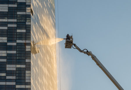 Fire men spraying water during fire fighting emergency exercise on modern office building in Amman, Jordanの写真素材