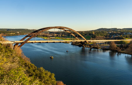 Pennybacker suspension bridge or 360 Bridge from overlook by Colorado River near Austin TXの写真素材