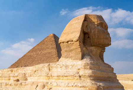 Great pyramid of Giza rises behind the Sphinx near Cairo Egyptの写真素材