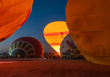 Inflating hot-air balloons for flight over Sahara desert and Valley of Kings near Luxor, Egyptの写真素材