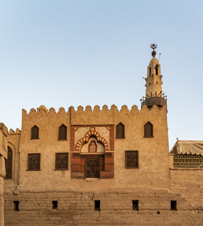 Abu Haggag mosque with a detailed entrance and a tall minaret under a clear sky and built inside the Luxor templeの写真素材