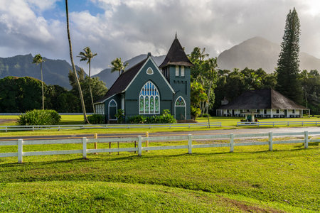 The Waioli Huiia Church stands in Hanalei, Kauai, with the majestic mountains in the background, after a heavy storm over the hillsの写真素材