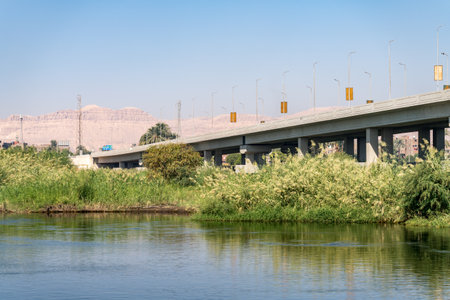 Modern Pont Qus Naqada road bridge crosses the Nile in Egypt with Sahara desert behindの写真素材