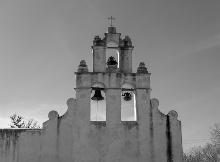 Monochrome view of San Juan mission church, a historic landmark near San Antonio, Texas, showcasing its weathered facade under a clear sky.の写真素材