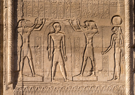 Bas-relief carvings of gods and kings on the well-preserved facade of the Temple of Esna with carvingsの写真素材
