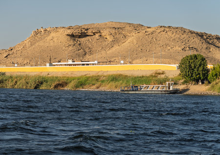 Railway station platform by the banks of the Nile with the desert behindの写真素材