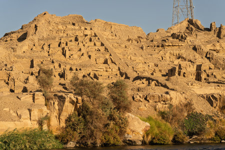 Excavations of ancient buildings by River Nile upstream from Edfu on riverbankの写真素材