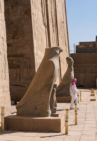 Detail of the carved statues of Horus outside the Pylon at the entrance of the massive temple in Edfu dedicated to Horus and Hathorの写真素材