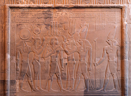 Details of the carvings on the walls of the Temples of Sobek and Horus at Kom Ombo with Isis among themの写真素材