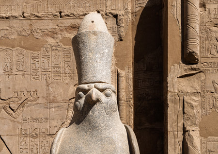 Detail of the carved statue of Horus outside the Pylon at the entrance of the massive temple in Edfu dedicated to Horus and Hathorの写真素材