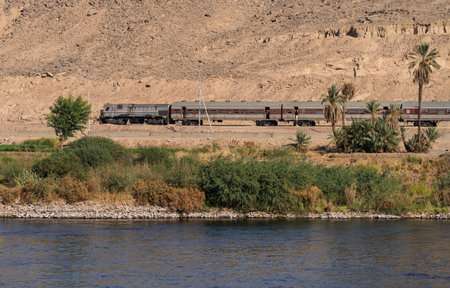 Egyptian passenger train alongside the River Nile near Aswan and heading northの写真素材