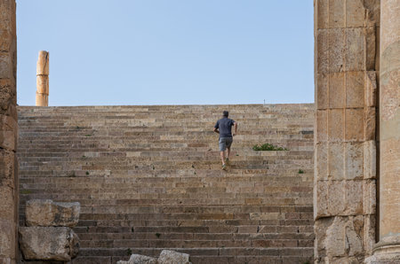 Tourist clims the staircase past the altar terrace of Sanctuary of Artemis on Cardo Maximus in...