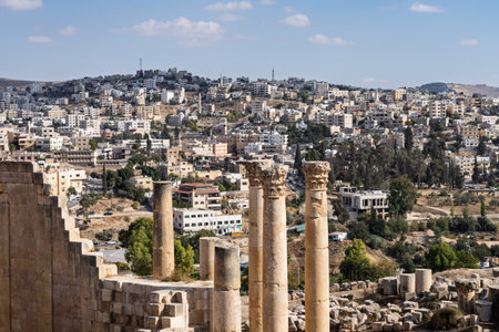 View down colonaded path towards the modern city in Jerash, a Greco-Roman well preserved city in Jordanの写真素材