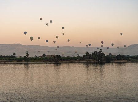 Many balloons in the sky over Nile River in Luxor for sunset flight over the Valley of the Kingsの写真素材
