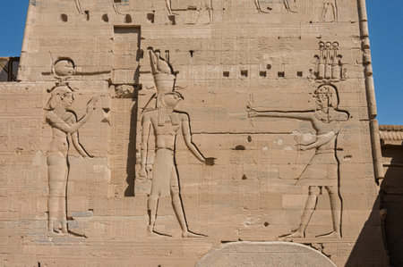 Detail of the bas-relief carving of the Isis and Horus facing Pharoah in the reconstructed Philae Temple in Aswan Harbor in Egyptの写真素材