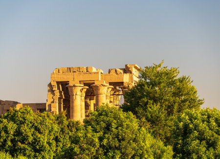 Magnificent temple of Sobek and Horus stands above the trees lining the River Nile at Kom Omboの写真素材